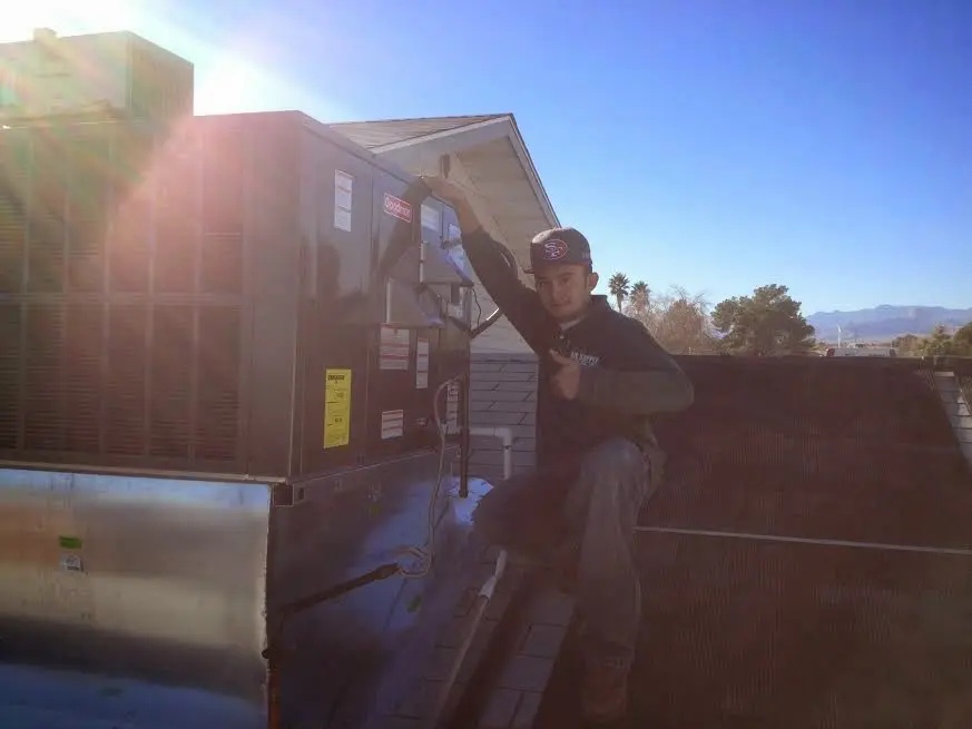 HVAC technician performing Air Duct Repair on a rooftop unit in Travelers Rest